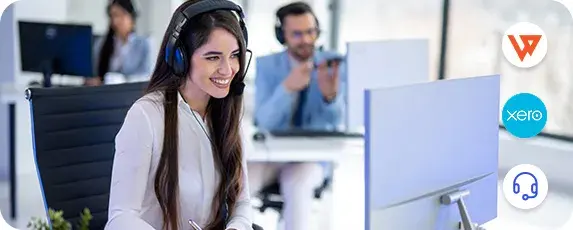 Support team member assisting customers on computer, representing solutions for common Xero issues and syncing errors.
