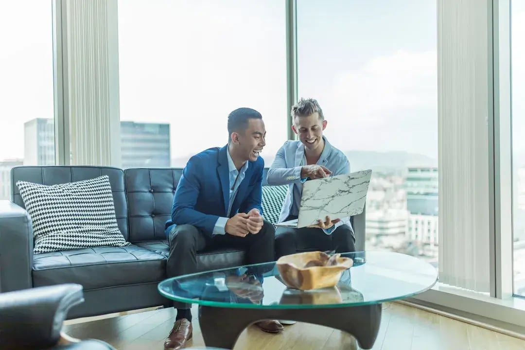 Two e-commerce professionals discussing AI tools for ecommerce automation, highlighting the future of ecommerce accounting with AI-driven solutions.